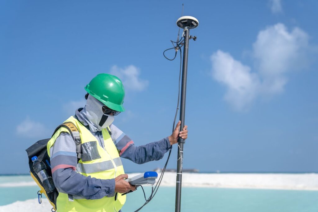 Man in Helmet, Goggles and Mask Standing with Device